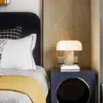 Elegant marble table lamp with soft glow on bedside table in bedroom