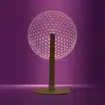 3D LED table lamp with wooden base and acrylic art glowing in a cozy room