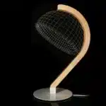 3D LED table lamp with wooden base and acrylic art glowing in a cozy room