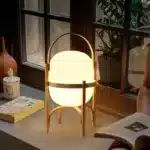 Modern table lamp with wood and glass base, minimalist design for bedroom or living room