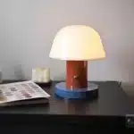 Nordic retro mushroom table lamp with warm LED glow on a bedside table