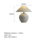 Wabi sabi table lamp with textured ceramic base and linen shade in a cozy living room