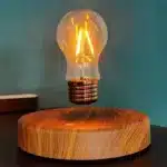 Floating LED lamp with levitating bulb on a wooden desk in a modern living room