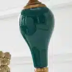 Green ceramic table lamp with European cloth shade in a modern living room setting
