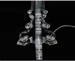Modern acrylic table lamp glowing softly on a bedside table in a contemporary bedroom