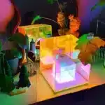3D pyramid night light with RGB color modes on a bedside table