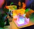 3D pyramid night light with RGB color modes on a bedside table