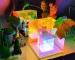 3D pyramid night light with RGB color modes on a bedside table