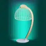 3D LED table lamp with wooden base and acrylic art glowing in a cozy room