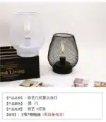 Decorative bird cage lamp with warm LED light, iron frame, and silk screen details on a bedside table