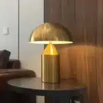 Modern mushroom table lamp with metal shade and wood base on bedside table