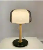 Modern bedside lamp with cream glass shade on a nightstand