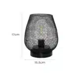 Decorative bird cage lamp with warm LED light, iron frame, and silk screen details on a bedside table