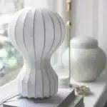 Wabi sabi floor lamp with textured fabric shade in a cozy living room corner