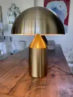 Modern mushroom table lamp with metal shade and wood base on bedside table