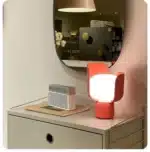 Rotating petal desk lamp with adjustable petals in pastel colors on a bedside table