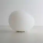 Modern table lamp with warm glow on bedside table
