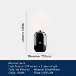 Modern table lamp with glass shade on bedside table