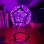 Dodecahedron gaming light with vibrant RGBW colors illuminating a gaming desk setup