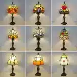 Tiffany table lamp with colorful stained glass shade casting warm glow on nightstand