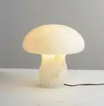 Elegant marble table lamp with soft glow on bedside table in bedroom