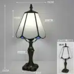 Tiffany table lamp with colorful stained glass shade casting warm glow on nightstand