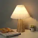 Handmade rattan bedside lamp with pleated shade on vintage nightstand