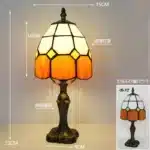 Tiffany table lamp with colorful stained glass shade casting warm glow on nightstand