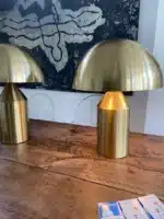 Modern mushroom table lamp with metal shade and wood base on bedside table