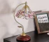 Vintage desk lamp with stained glass butterfly shade casting warm glow on bedside table