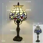 Tiffany table lamp with colorful stained glass shade casting warm glow on nightstand