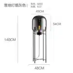 Modern floor lamp with iron frame and glass shade in a cozy living room