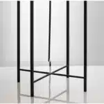 Modern floor lamp with iron frame and glass shade in a cozy living room
