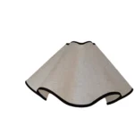 Elegant handmade petal lampshade casting a warm glow in a cozy bedroom
