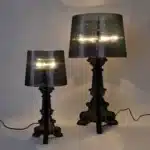 Modern acrylic table lamp glowing softly on a bedside table in a contemporary bedroom