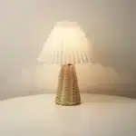 Handmade rattan bedside lamp with pleated shade on vintage nightstand