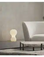 Wabi sabi floor lamp with textured fabric shade in a cozy living room corner