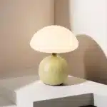 Mushroom table lamp with cream ceramic shade on bedside table