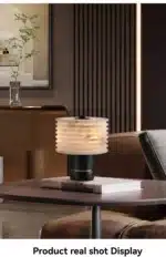 Elegant marble table lamp with soft glow on bedside table in bedroom