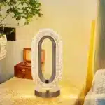 Elegant oval crystal table lamp with USB charging on a bedside table