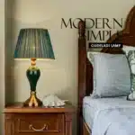 Green ceramic table lamp with European cloth shade in a modern living room setting