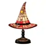 Witch hat lamp with stained glass pattern casting a warm glow on a bedside table