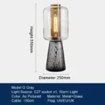 Modern table lamp with glass shade on bedside table
