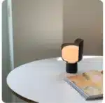 Rotating petal desk lamp with adjustable petals in pastel colors on a bedside table