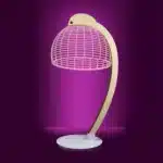 3D LED table lamp with wooden base and acrylic art glowing in a cozy room