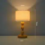 Vintage table lamp with fabric shade and solid wood base on bedside table