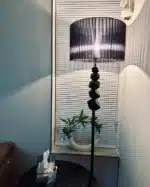 Modern crystal floor lamp with black finish and LED light in a living room