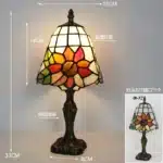 Tiffany table lamp with colorful stained glass shade casting warm glow on nightstand