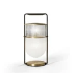 Modern table lamp with glass shade on bedside table