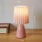 Milkshake bedside table lamp with warm LED light on a nightstand in a cozy bedroom